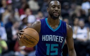 Kemba Wlaker dribbles up court