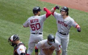 Mookie Betts and Andrew Benintendi celebrate at home.