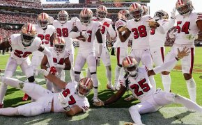 49ers defense posing for a picture in the end zone