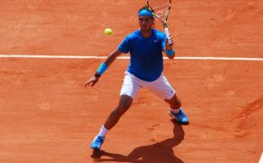 Rafael Nadal sets to make a return shot