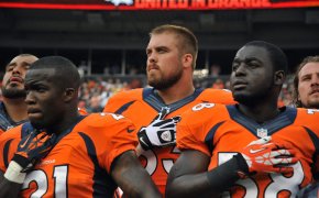 Three Denver Broncos standing for the National Anthem