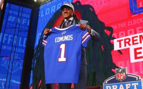 Tremaine Edmunds holds up a jersey and takes a photo after being chosen by the Buffalo Bills