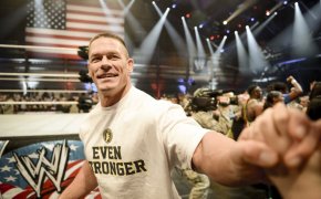 Professional wrestler John Cena shakes hands with a child, Dec. 11, 2013, at the conclusion of the WWE Tribute to the Troops event at Joint Base Lewis-McChord, Wash. The event entertained approximately 4,000 service members and family members stationed throughout the Puget Sound area.