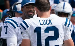 Jacoby Brissett high fiving Andrew Luck on the Colts sideline