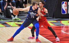 Luka Doncic backing down Trae Young.
