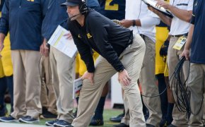 Jim Harbaugh watching play from the sidelines