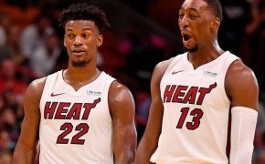 Jimmy Butler and Bam Adebayo reacting during a stoppage in play