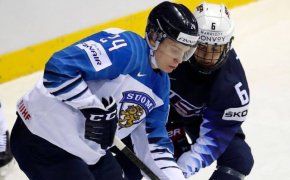 Kappo Kakko and Jack Hughes battling for the puck at the 2019 IIHF World Championships.