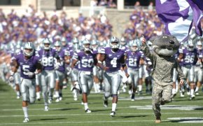 Wildcat Willie, the Kansas State University Mascot, runs on to the field with the Kansas State Football Team