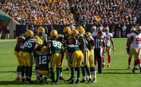 Packers huddling on the field