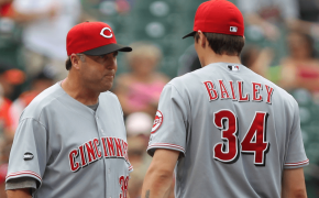 Bryan Price talks to Homer Bailey on the mound.