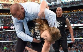 Ronda Rousey flipping HHH out of a ring at Wrestlemania 32