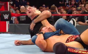 Shane McMahon puts an armbar on The Miz.