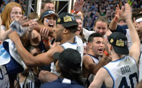 Phil Booth celebrating Villanova's 2018 national championship with fans and teammates.