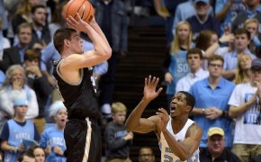 Wofford guard Fletcher Magee skies above UNC's Kenny Williams to shoot a jumper.