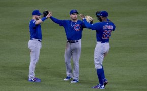 Chicago Cubs outfielders celebrating a win.