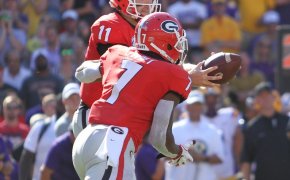 Jake Fromm hands the ball off