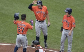 Astros teammates high-fiving at home plate
