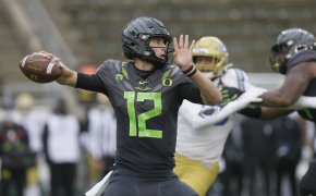 Oregon's quarterback Tyler Shough throwing a football downfield during a game.