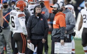 Cleveland Browns head coach Kevin Stefanski talking with quarterback Baker Mayfield on the sidelines during a game.
