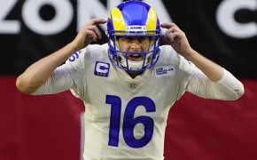 Jared Goff pointing to his helmet waiting for snap