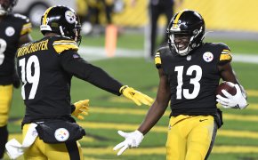 Pittsburgh Steelers wide receiver James Washington celebrates with JuJu Smith-Schuster on the field during a game.