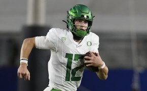Oregon quarterback Tyler Shough running the ball during the first half of a game.