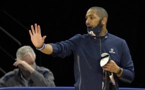 LaVall Jordan holding right hand out directing players with mask on