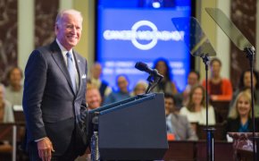 Joe Biden smiling on stage at a campaign event