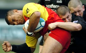 Perpignan's Bernard Gouta is tackled by Newcastle Falcon's Tom May