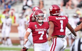 Oklahoma Sooners QB Spencer Rattler celebrating with running back Seth McGowen on the field.