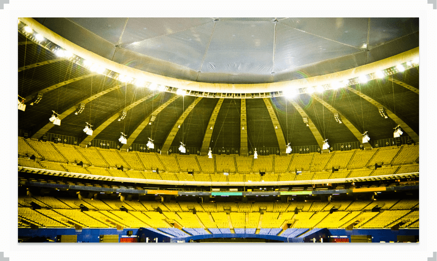 Large empty stadium with yellow and blue seats