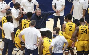 West Virginia coach Bob Huggins speaks with players