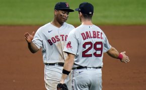 Boston Red Sox third baseman Rafael Devers hig-fiving teammate Bobby Dalbec