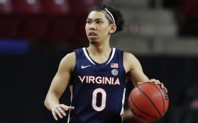 Virginia men's basketball player Kihel Clark dribbling the ball in the middle of a NCAA game.