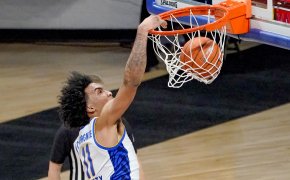 Pittsburgh's Justin Champagnie dunking during a NCAA men's basketball game.
