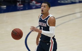 Gonzaga guard Jalen Suggs dribbling the ball up the court during a NCAA men's basketball game.