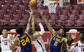 Cameron Thomas and Trendon Watford converge on Alabama player in the paint and contest his shot