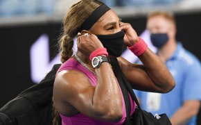 Serena Williams adjusting her mask as she leave the court following a match.