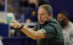 Michigan State head coach Tom Izzo yelling and pointing from the sidelines during a NCAA men's basketball game.