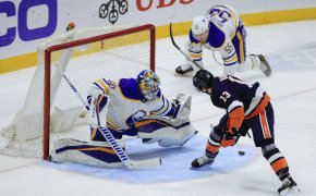 New York Islanders' Mathew Barzal scoring past Buffalo Sabres goaltender Carter Hutton in an NHL game.