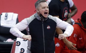 Chris Holtmann mask down yelling on the court