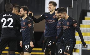 Manchester City's John Stones celebrating with teammates after scoring the opening goal during a soccer match.