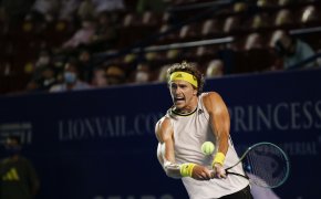 Alexander Zverev returning a ball with a backhand during a tennis match in Mexico.