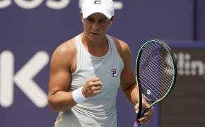 Ashleigh Barty celebrating a point with a first pump during a tennis match.