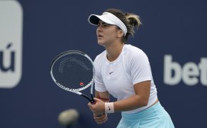 Bianca Andreescu getting ready to return a serve during a tennis match.