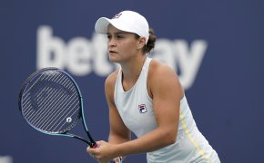 Ashleigh Barty waiting for a serve from her opponent during a tennis match.