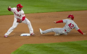 St Louis Cardinals Tommy Edmann sliding into second base as Phillies second baseman is turning the double play.