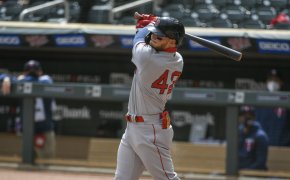 Boston Red Sox's Alex Verdugo following through on a swing during an at bat.