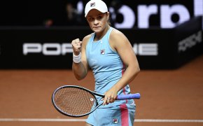 Ashleigh Barty reacting with a fistpump after scoring a point during a tennis match.
